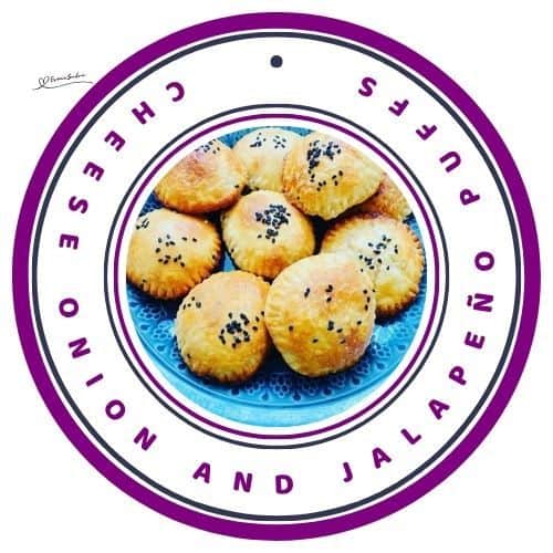 an image of Cheese Onion and Jalapeño Puffs served on a blue plate and sprinkled with black poppy seeds