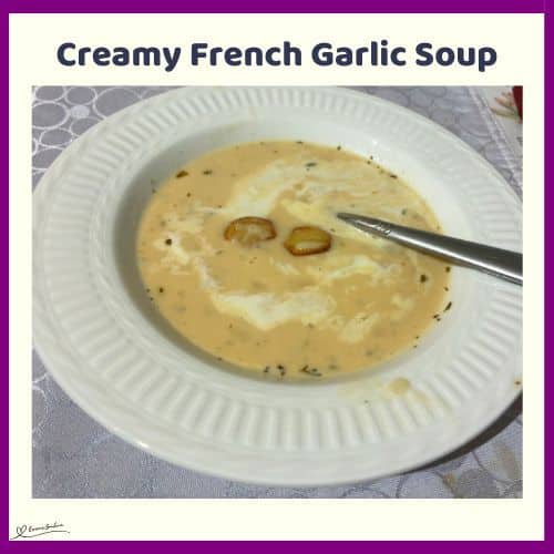 an image of a white soup bowl filled with Creamy French Garlic Soup