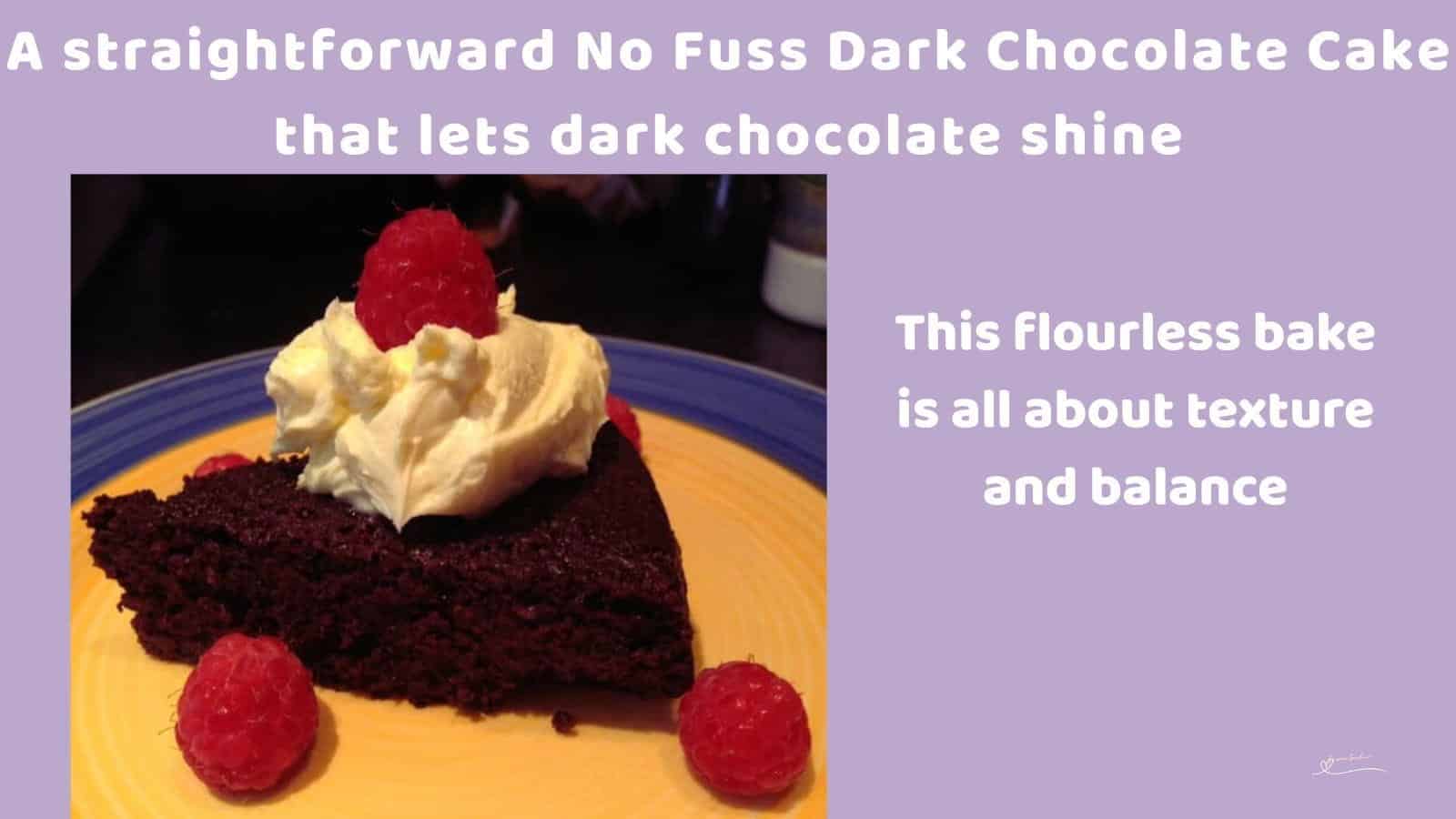 An image of a No Fuss Dark Chocolate Cake with a small dollop of cream and a few raspberries