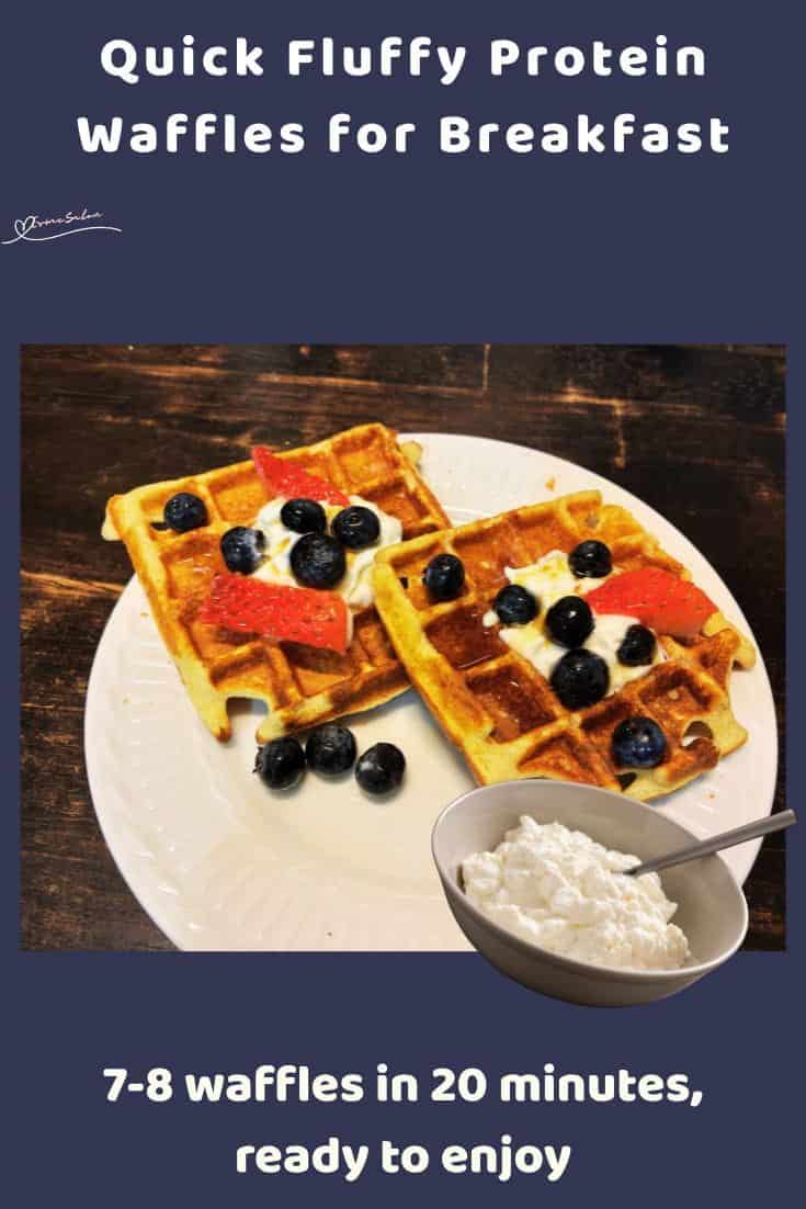 An image of Fluffy Protein Waffles with a dollop of cream, blue berries and strawberries