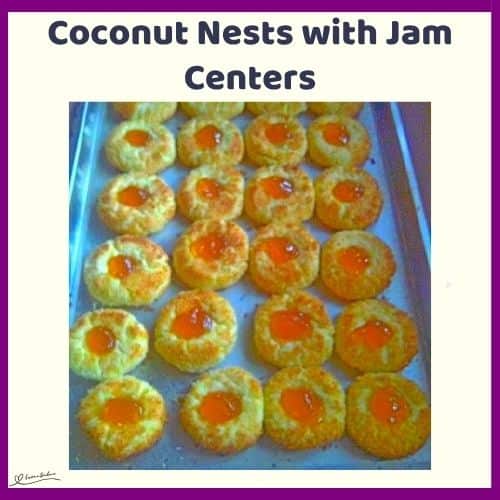 An image of Coconut Nests with Jam Centers on a blue platter