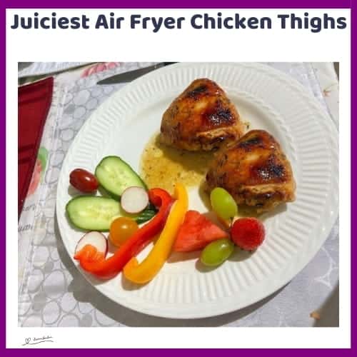 An image of a plate of Juiciest Air Fryer Chicken Thighs with a side of salad